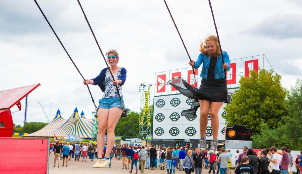 Two girls at Festival Lowlands on a swing Two girls at Festival Lowlands on a swing
