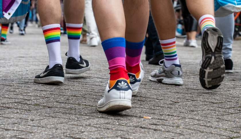 People with rainbow socks walking on the street People with rainbow socks walking on the street