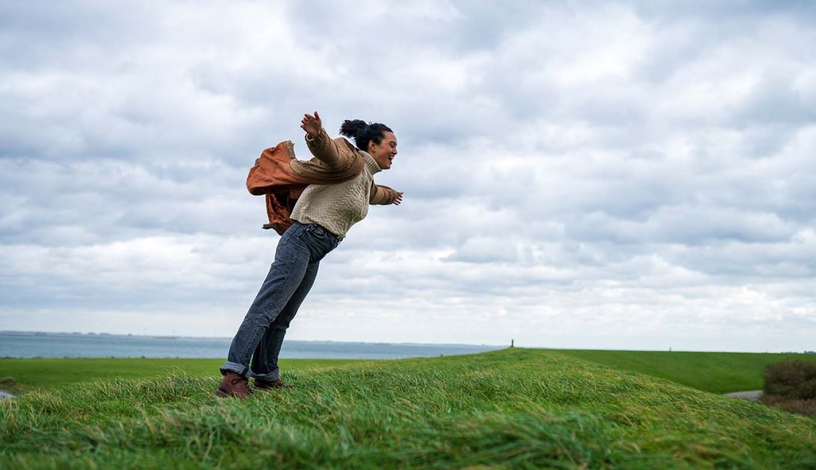 Woman hangs against strong headwinds in Zeeland Woman hangs against strong headwinds in Zeeland
