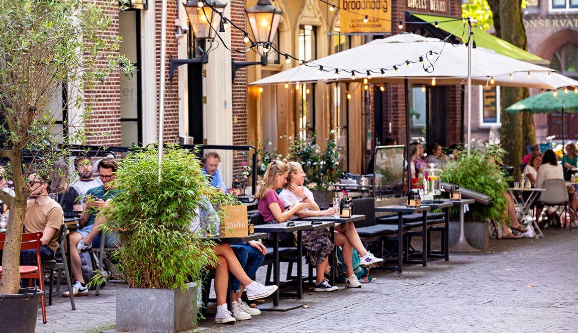People on terraces at Mariaplaats in Utrecht People on terraces at Mariaplaats in Utrecht