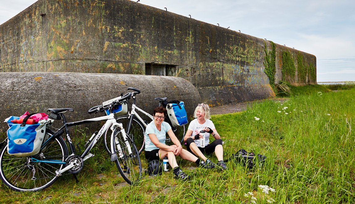 Cyclists take a break at the bunker on the Afsluitdijk Cyclists take a break at the bunker on the Afsluitdijk