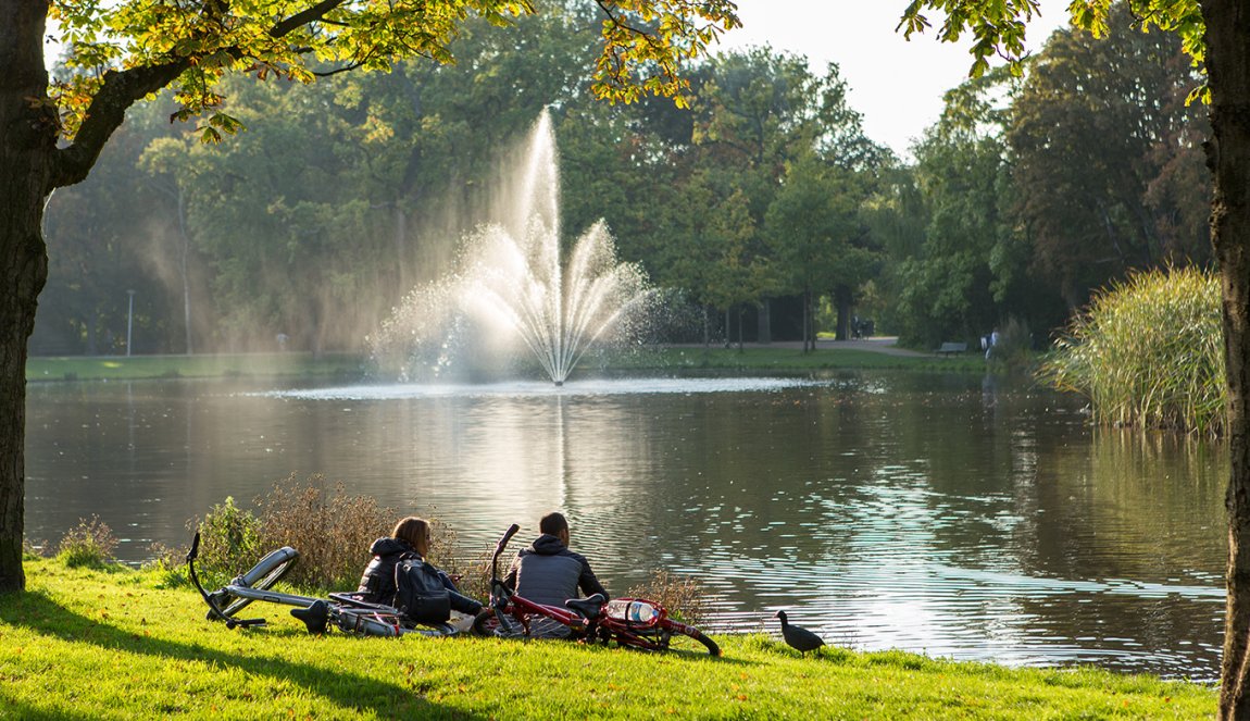 Amsterdam Vondelpark people sitting on waterfront Amsterdam Vondelpark people sitting on waterfront