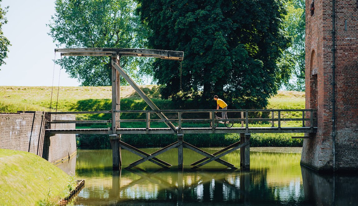 Sietse van Berkel cycling over drawbridge Sietse van Berkel cycling over drawbridge