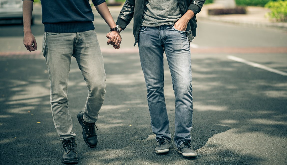 Men walking hand in hand on the street Men walking hand in hand on the street