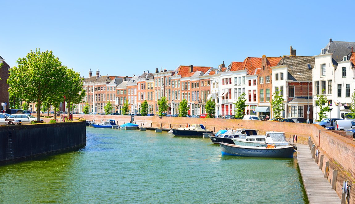 View of Middelburg with beautiful houses and boats along the canal. View of Middelburg with beautiful houses and boats along the canal.