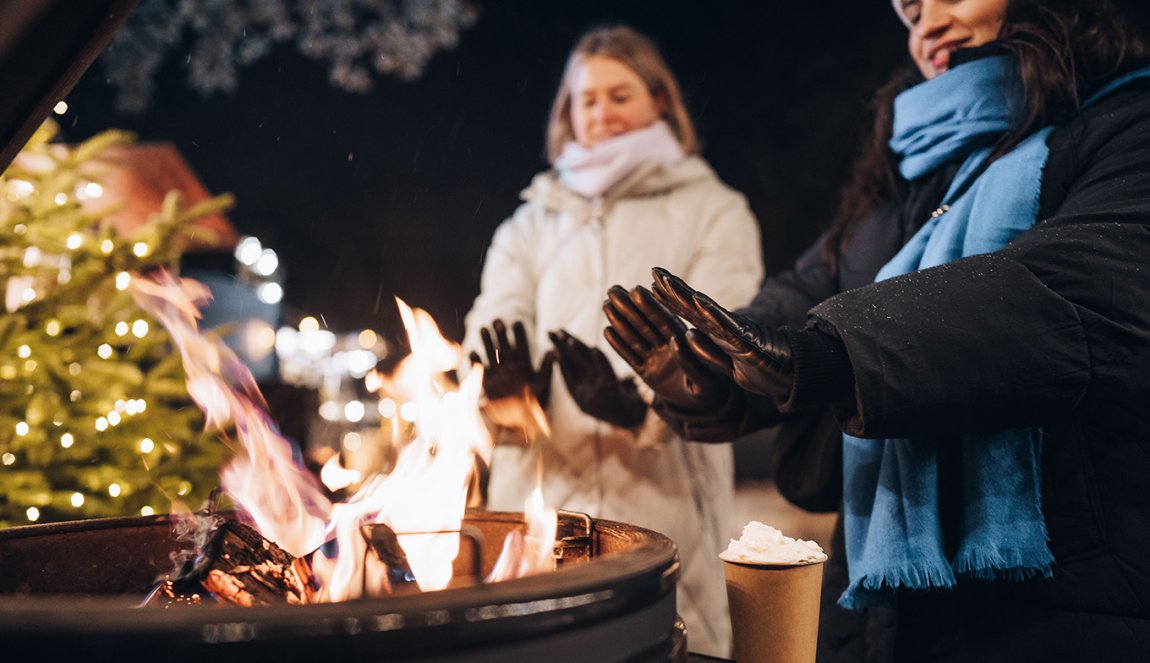 Warm hands by fire with hot chocolate Warm hands by fire with hot chocolate