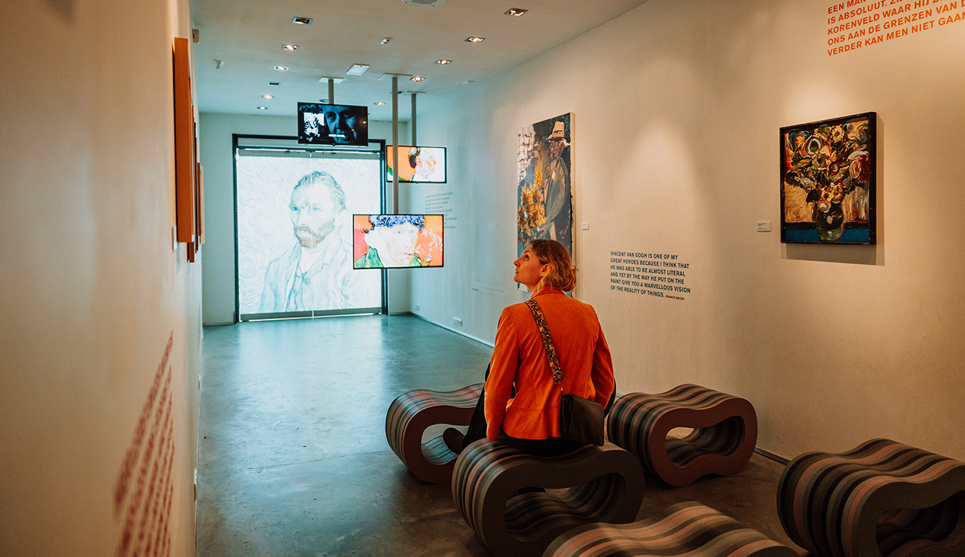 Lady looks at exhibition in Vincent van Gogh House Lady looks at exhibition in Vincent van Gogh House