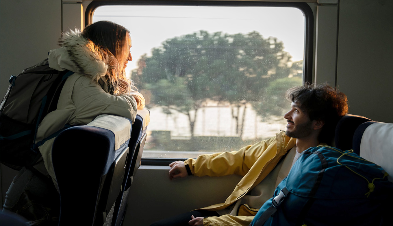 Couple travelling with luggage in train Couple travelling with luggage in train