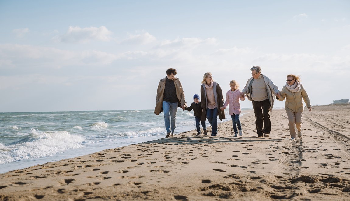Family walk together on beach by the sea Family walk together on beach by the sea
