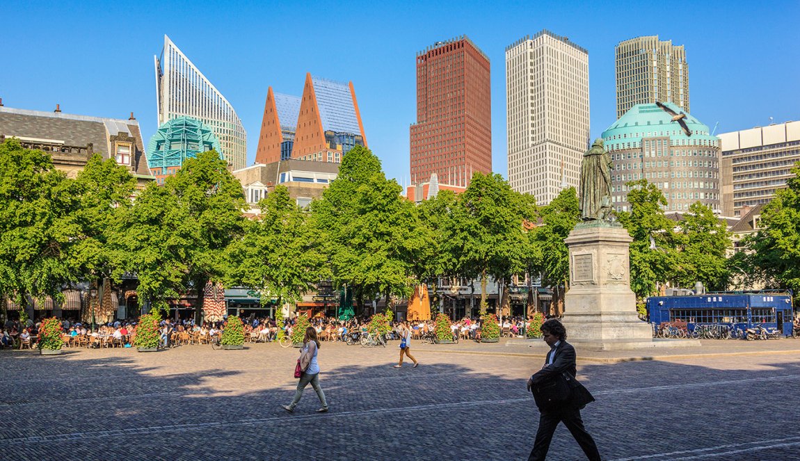 Strollers on the Plein with The Hague skyline in the background Strollers on the Plein with The Hague skyline in the background
