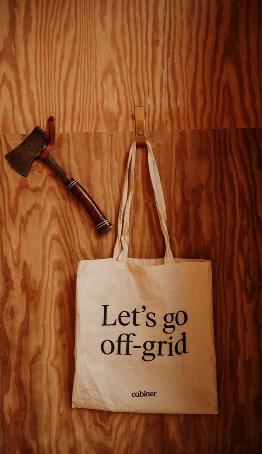 Axe and bag with text 'Let's go off-grid' at Cabiner Axe and bag with text 'Let's go off-grid' at Cabiner